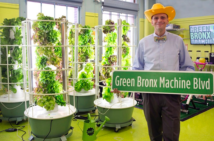 Stephen Ritz holding Green Bonx Machine Blvd sign