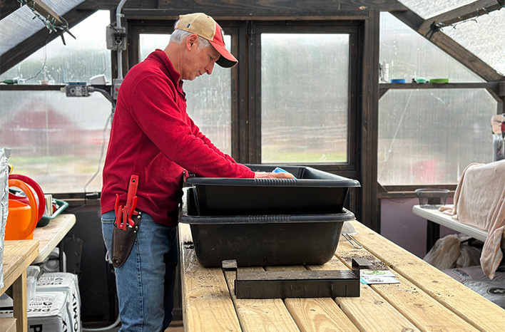 Joe mixing soil in the greenhouse